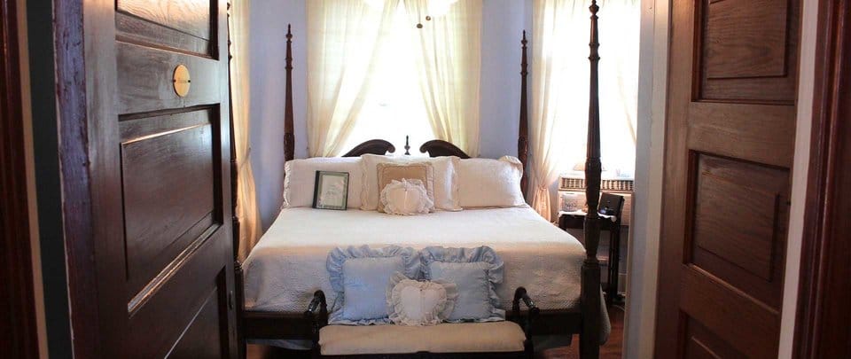 Not only does the bed above faces the door in a “coffin position”, the head of bed is also under a window. Both of which should be avoided. bed under window and facing door is bad feng shui - When Feng Shui Bed Placement Rules Conflict: Which Should You Use?