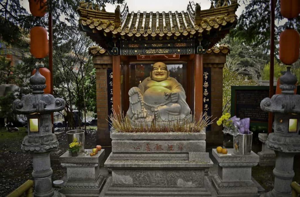 Incense, flowers, and fruits are offered to this statue of Laughing Buddha. buddhist temple laughing buddha incense flower offering 1024x675 - 3 Feng Shui Rules Related to Ghosts and the Supernatural
