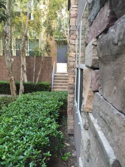 An illustration of Corner Sha that just barely missed the front door of another condominium. Building Corner facing front door bad feng shui min - Avoid These 5 Types of Bad Feng Shui Outside Your Home
