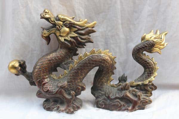 A dragon figurine. Fengshui Bronze Dragon Statue min - 30 Feng Shui Products & Items: Meaning, Use, and Placement