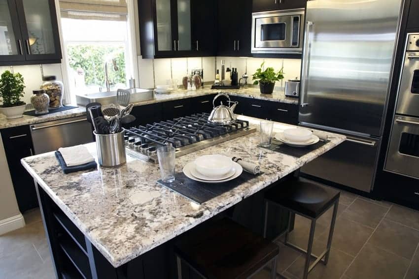 Some experts say that stove on center island allows you to cook in the “command position”. light color granite topped kitchen island stove bad feng shui - 33 Kitchen Feng Shui Rules and Tips – Location, Stove, and Basics